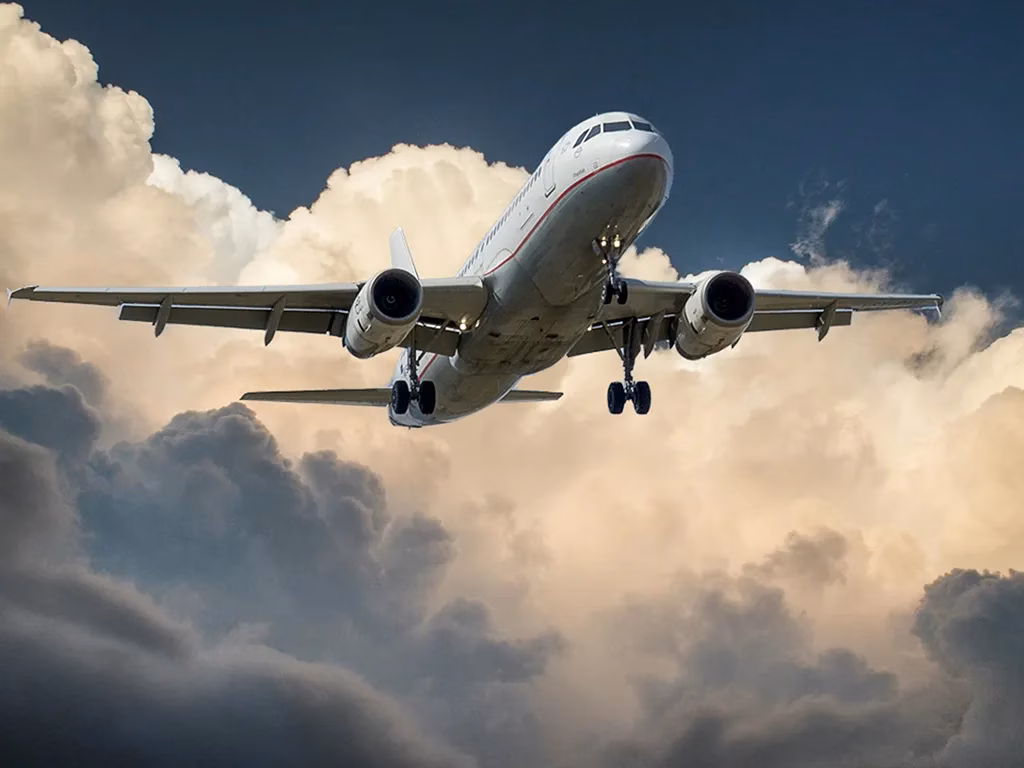 An commercial airplane that has just taken off, the landing gear is still down.