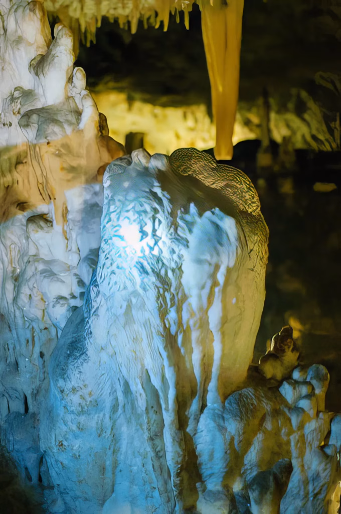 A picture from within one of the caves of a very colorful stalactites and stalagmites.